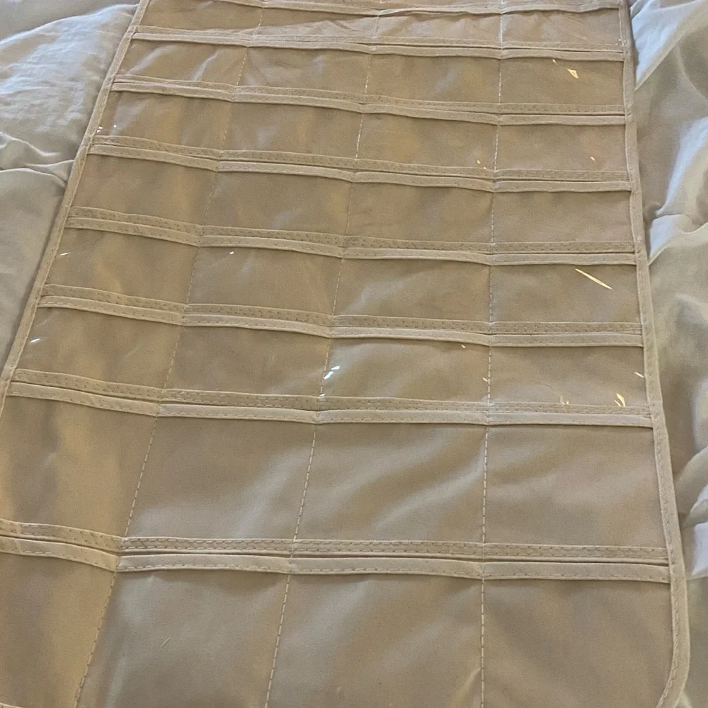 Hanging organizer, never used. Plastic inserts, canvas base.